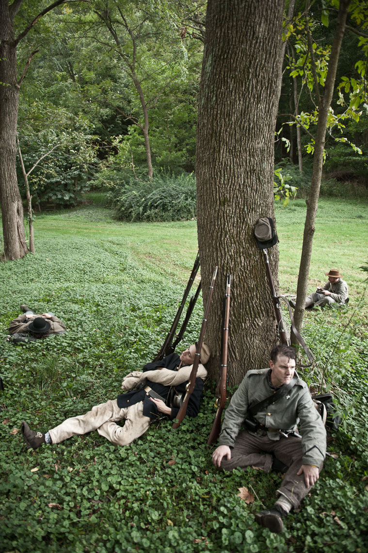 Civil War reenactors at Antietam: reenactor rest in the woods along the march