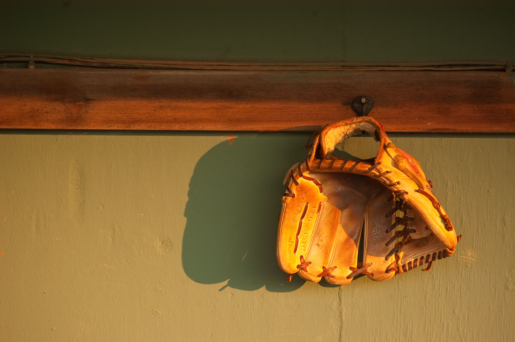 A glove hangs in the Bowie Baysox dugout, Prince George