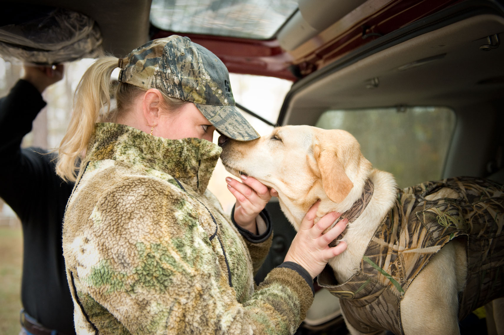 Hunting for waterfowl on the Eastern Shore of Maryland: A female hunter bonds with her dog before the hunt begins