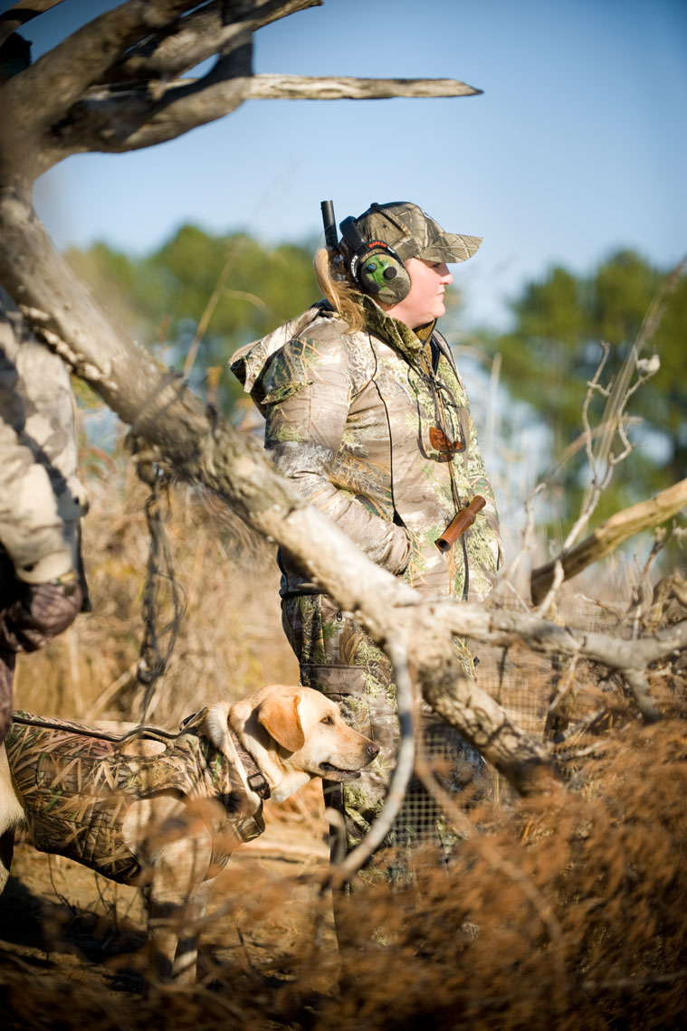 Hunting for waterfowl on the Eastern Shore of Maryland: a female hunter stands with her retriever