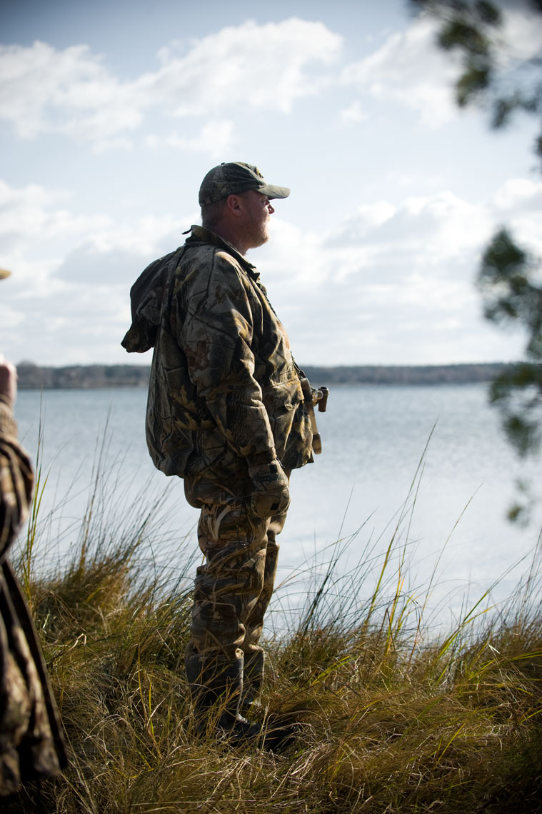 Hunting for waterfowl on the Eastern Shore of Maryland: a hunter scans the horizon from incoming birds