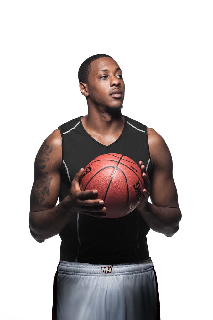 Mario Chalmers holding a basketball in front of a white background