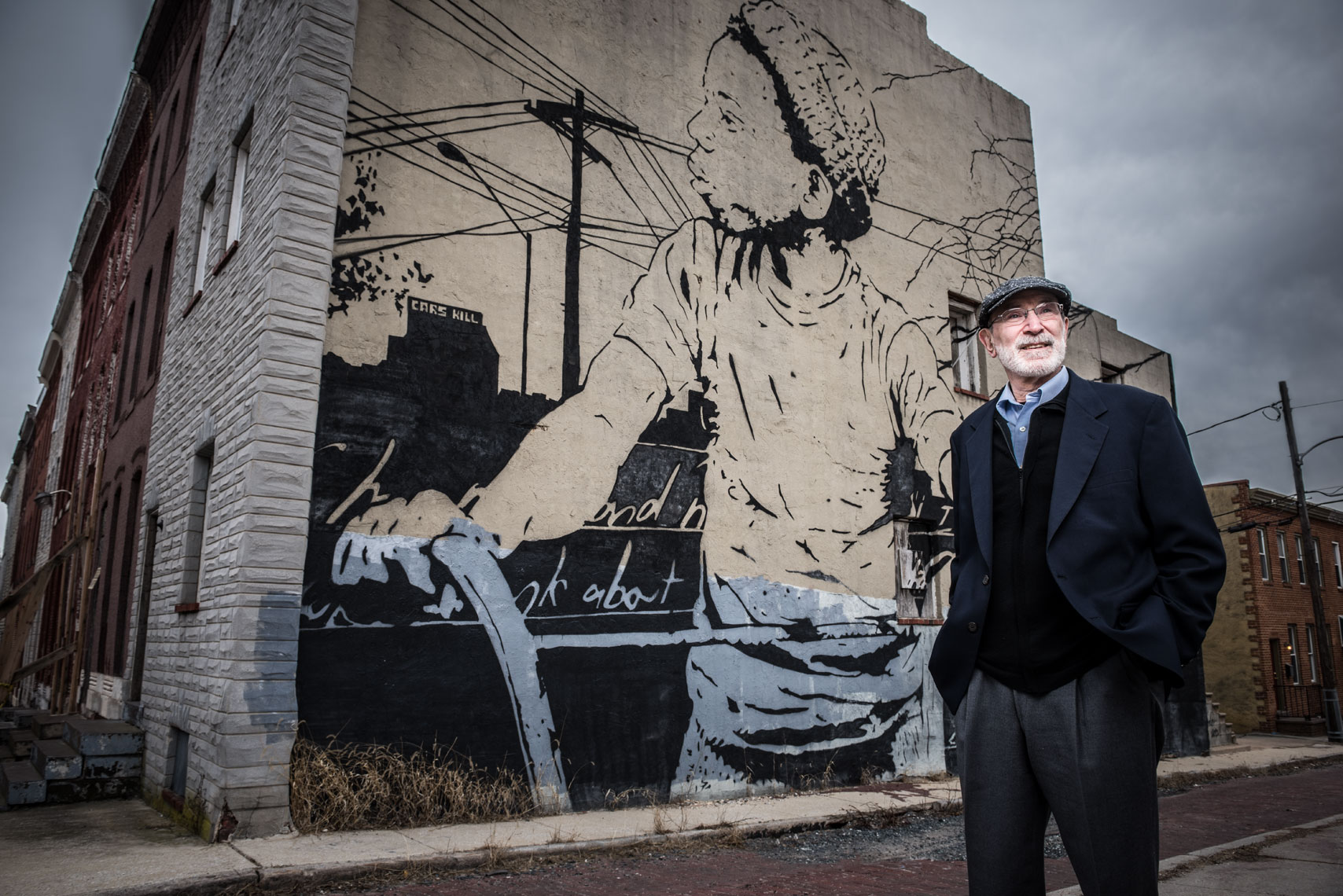  Johns Hopkins sociologist and author Dr. Karl Alexander standing in front of a mural on the streets of Baltimore.
