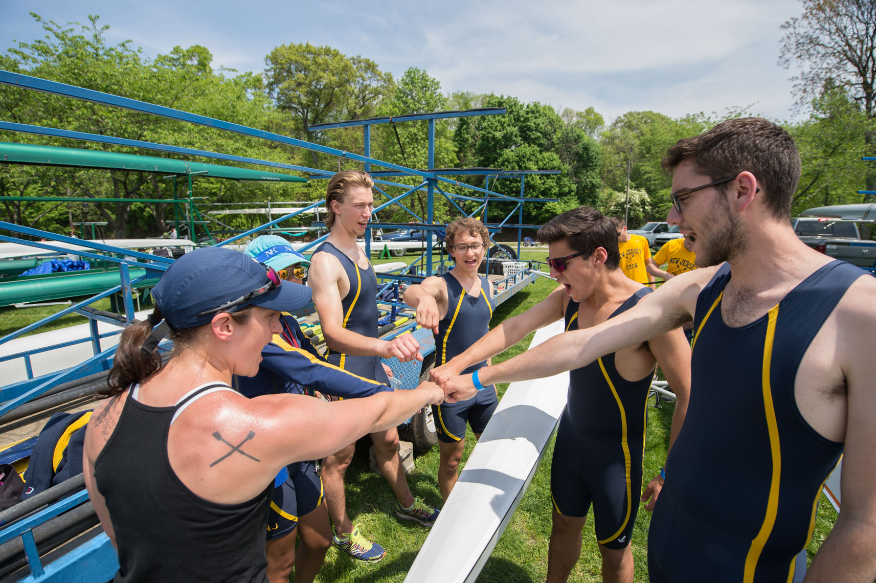 The TCNJ crew team put their hands together before the start of a race