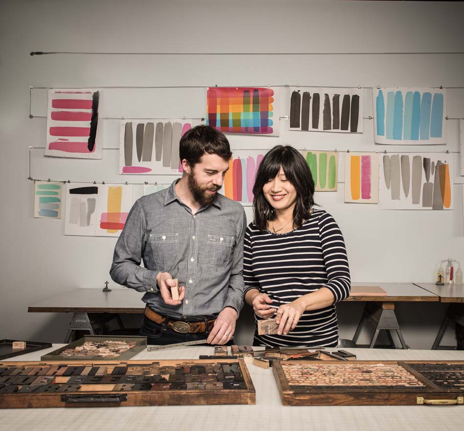Happy couple working together in a print shop