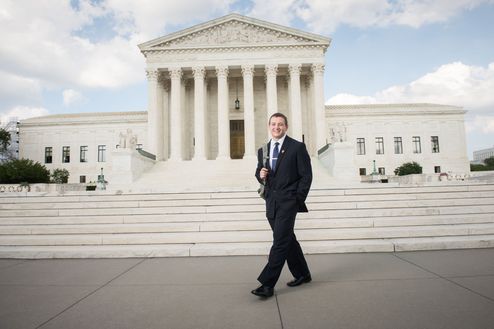 Tom Cilla walks past the US Supreme Court building wearing a backpack