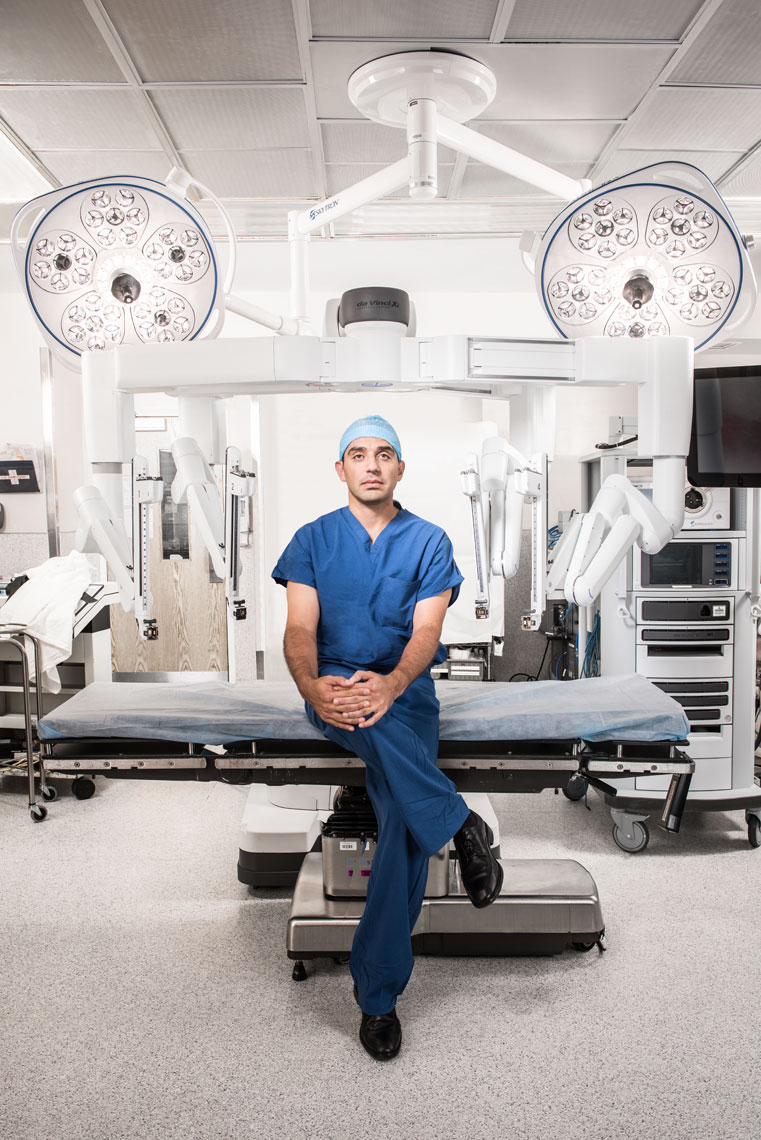 Urologist Dr. Mohamad Allaf seated in front of a a Da Vinci machine in the operating room