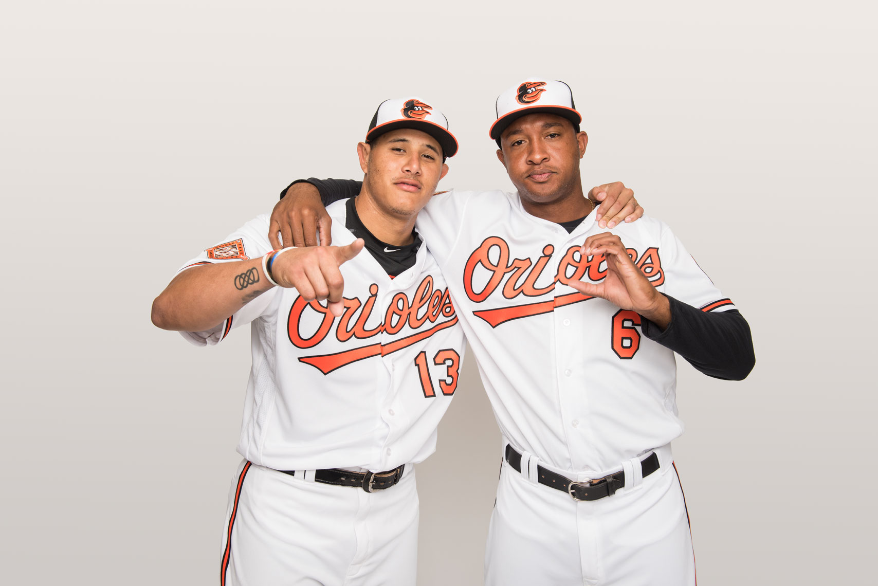 Manny Machado and Jonathan Schoop with their arms around each other