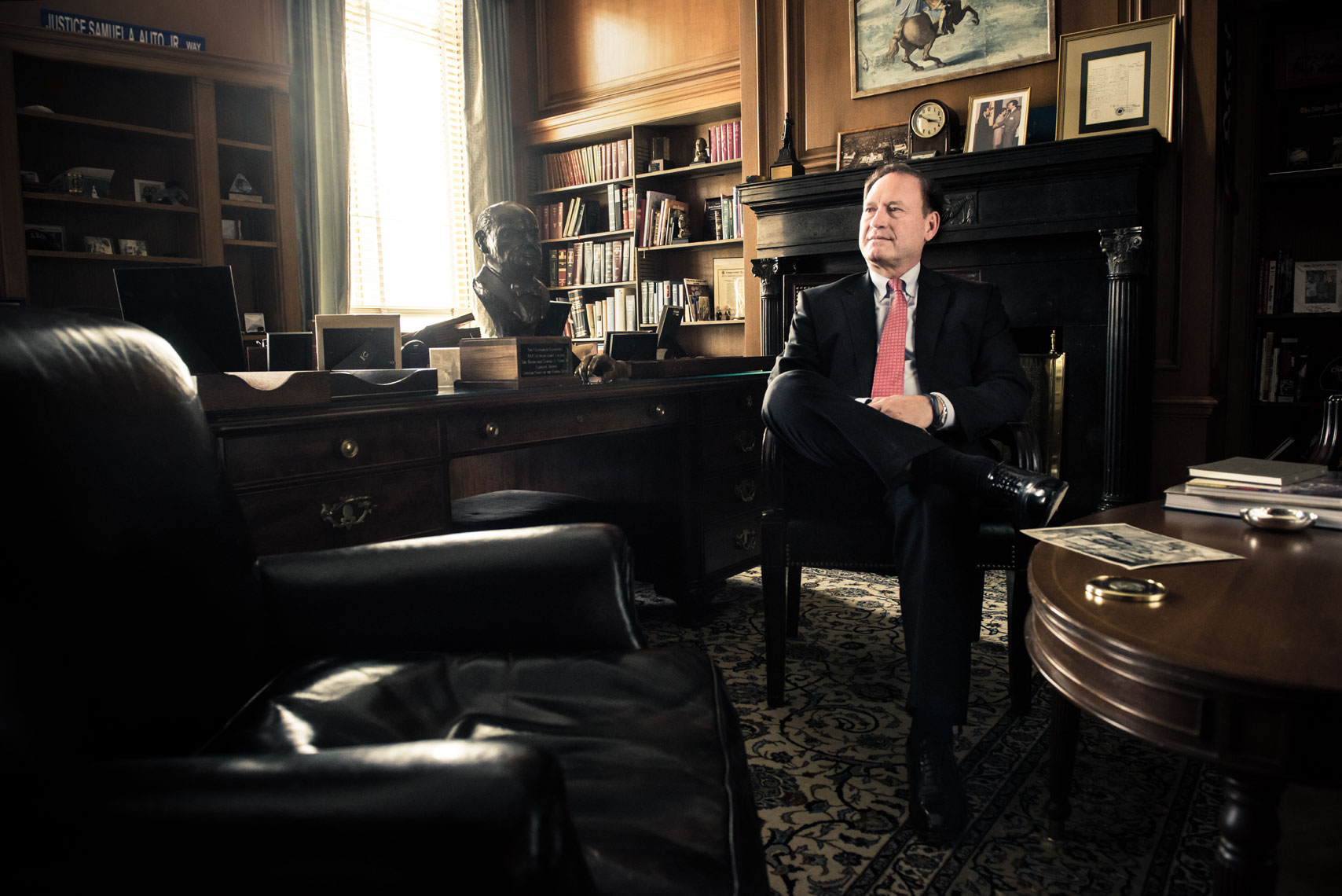 Supreme Court Justice Samuel Alito seated in a chair in his office