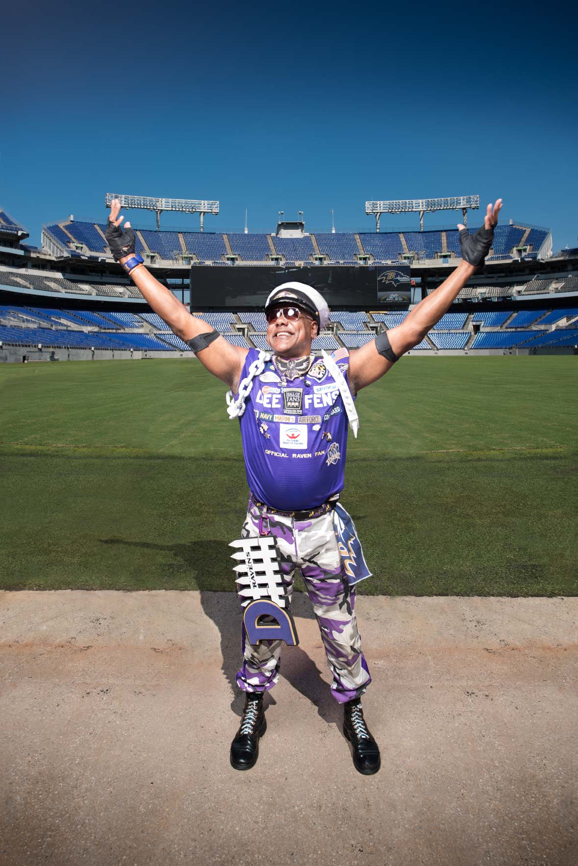 Captain Dee-Fense on the Ravens field with his arms spread wide