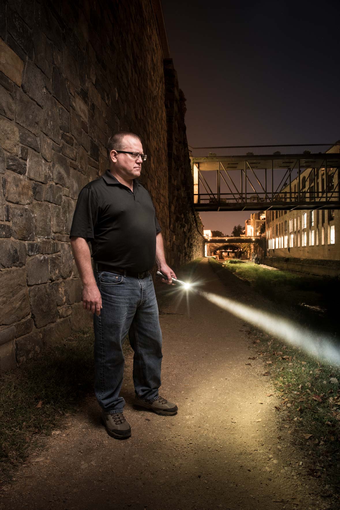 Private investigator Todd Troutner holding a flashlight on the C&O Canal