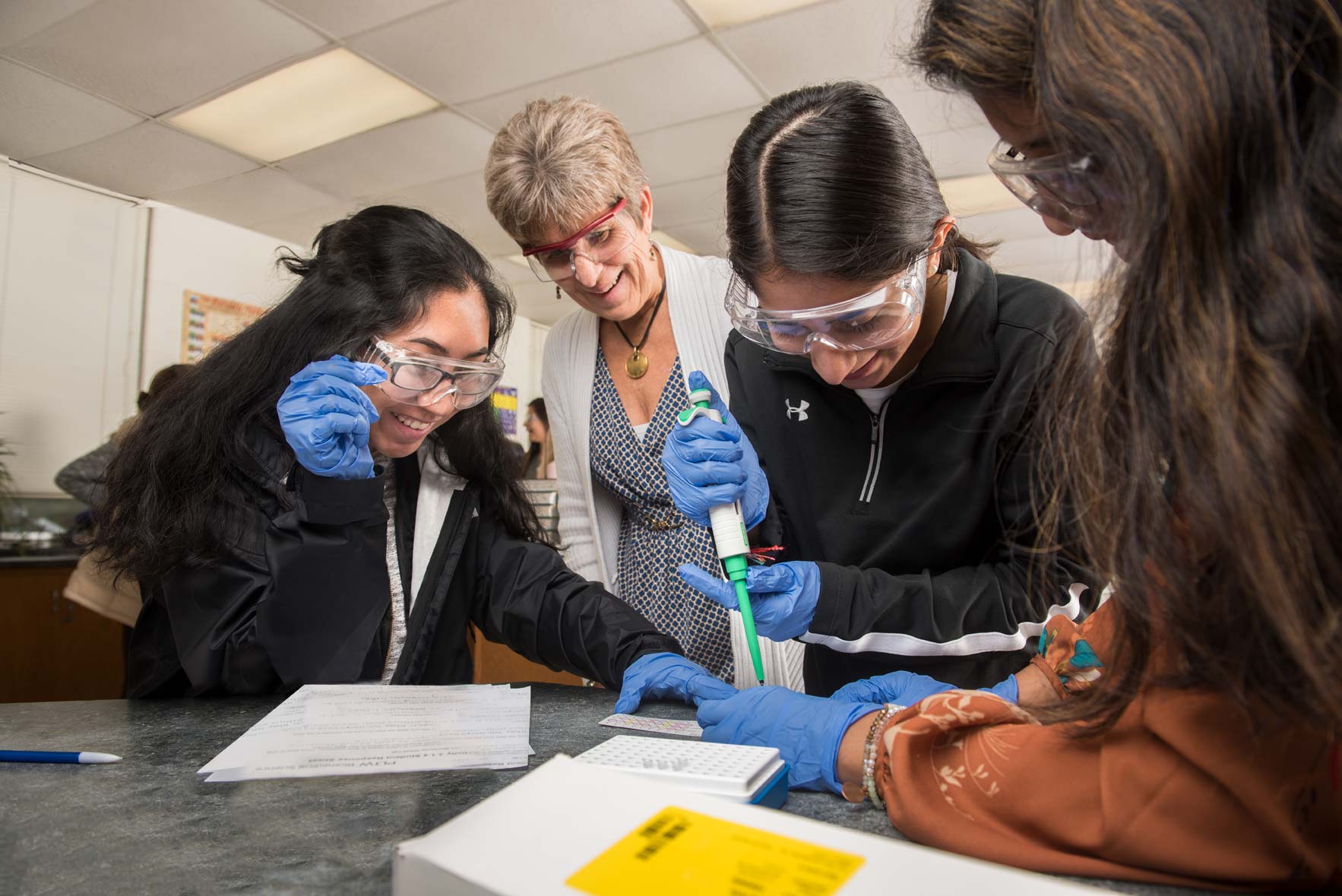 Easton High School ROP students work on a chemistry project as their teacher watches