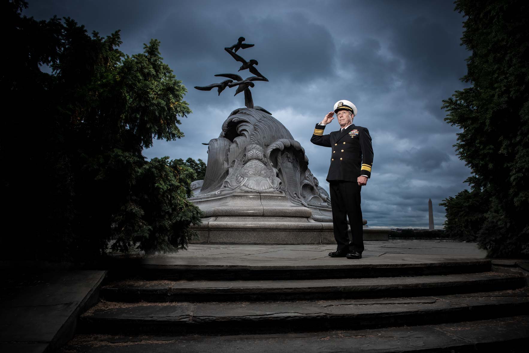 Admiral Jonathan White saluting in uniform at the Merchant Marine Memorial