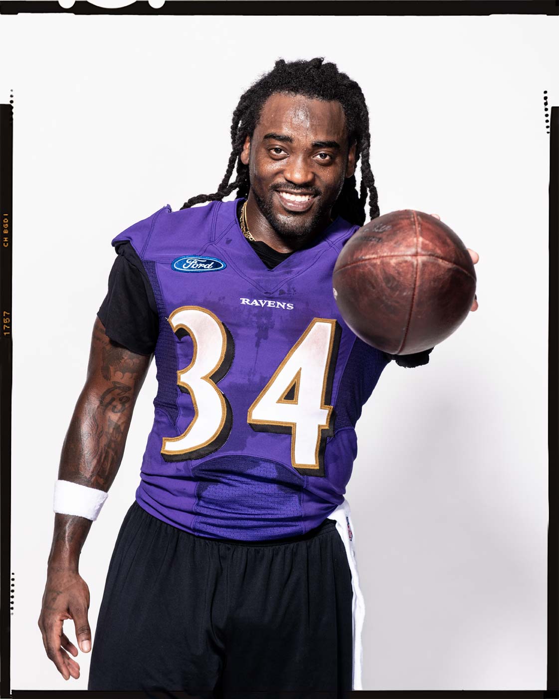 Baltimore Ravens running back Alex Collins pointing a football at the camera