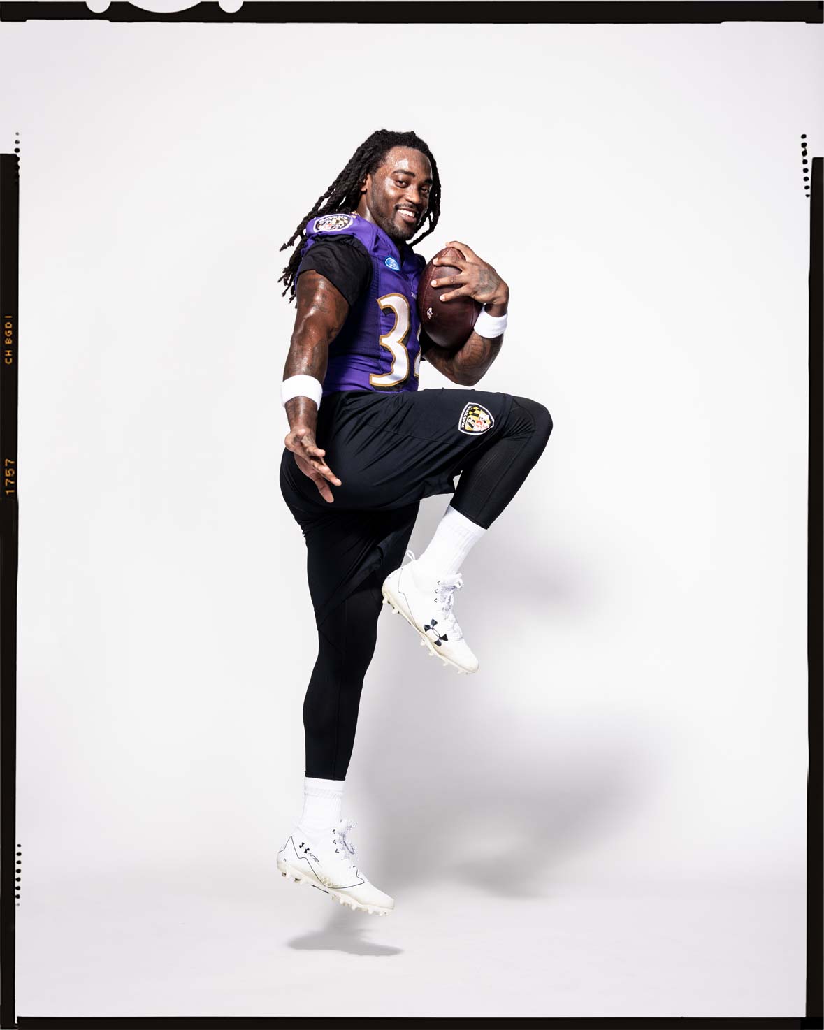 Baltimore Ravens running back Alex Collins striking a Heisman pose in uniform