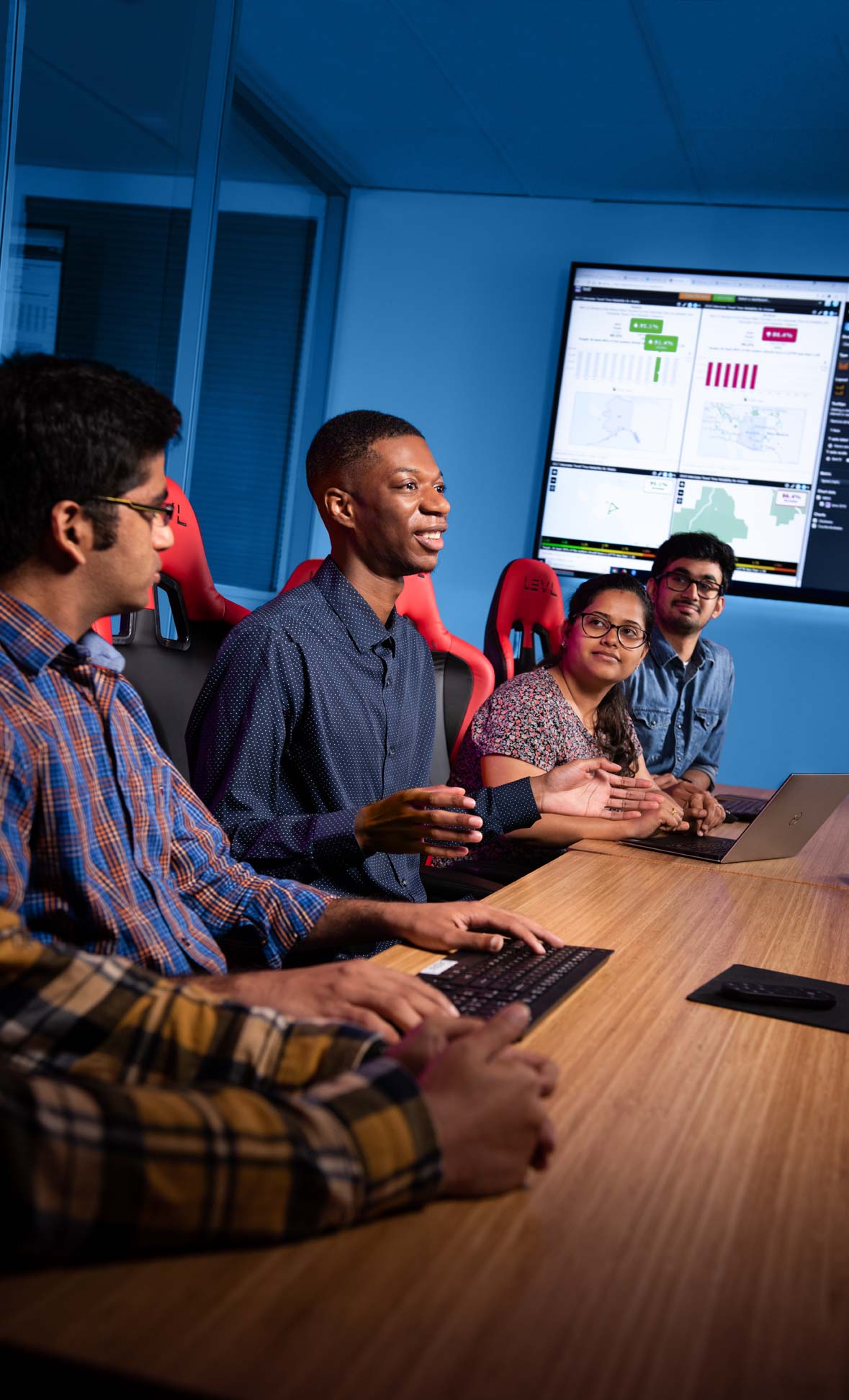 Students talking at a table in a digital classroom