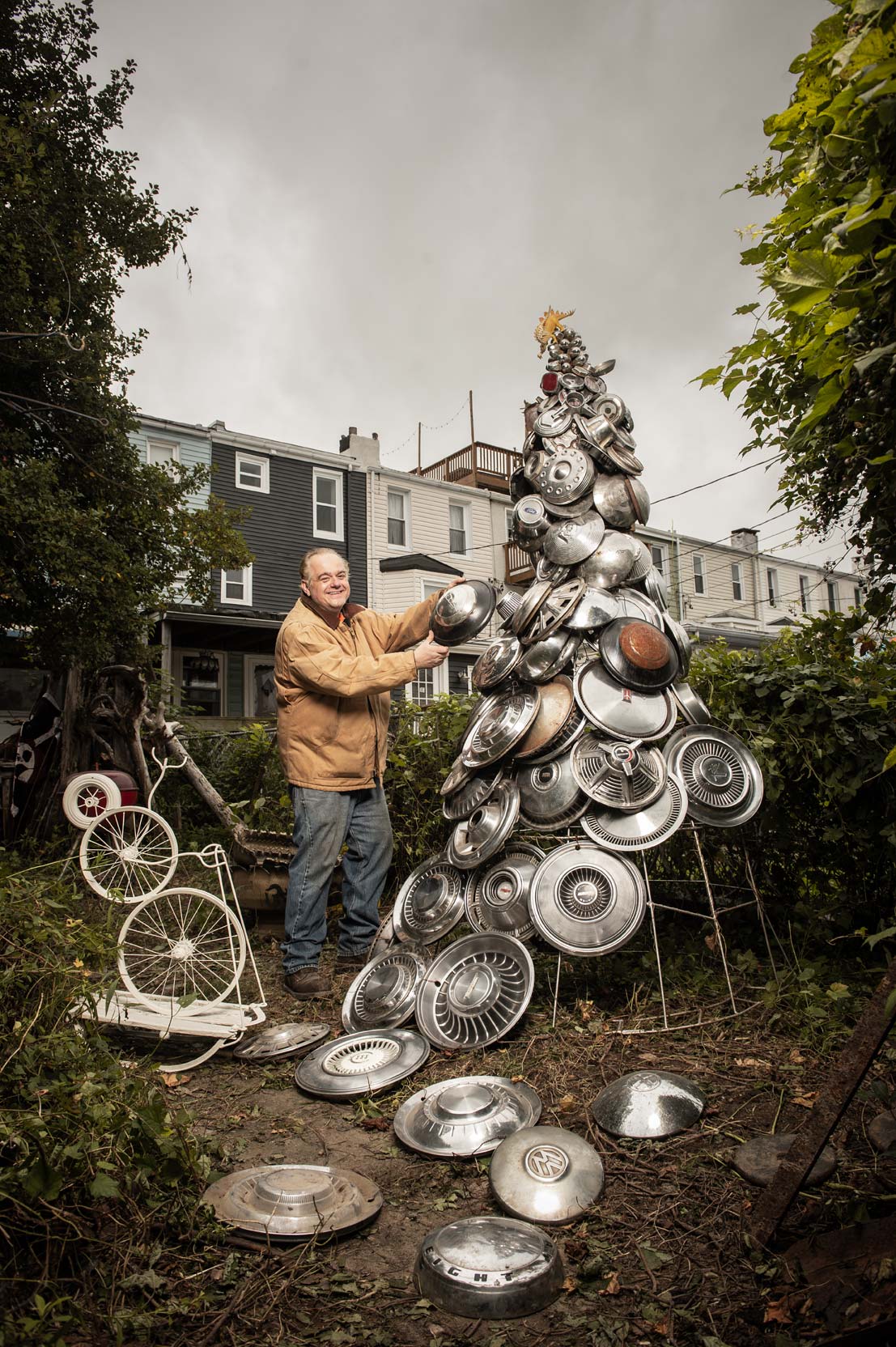 Jim Pollock placing a hubcap on his hubcap tree for Baltimore