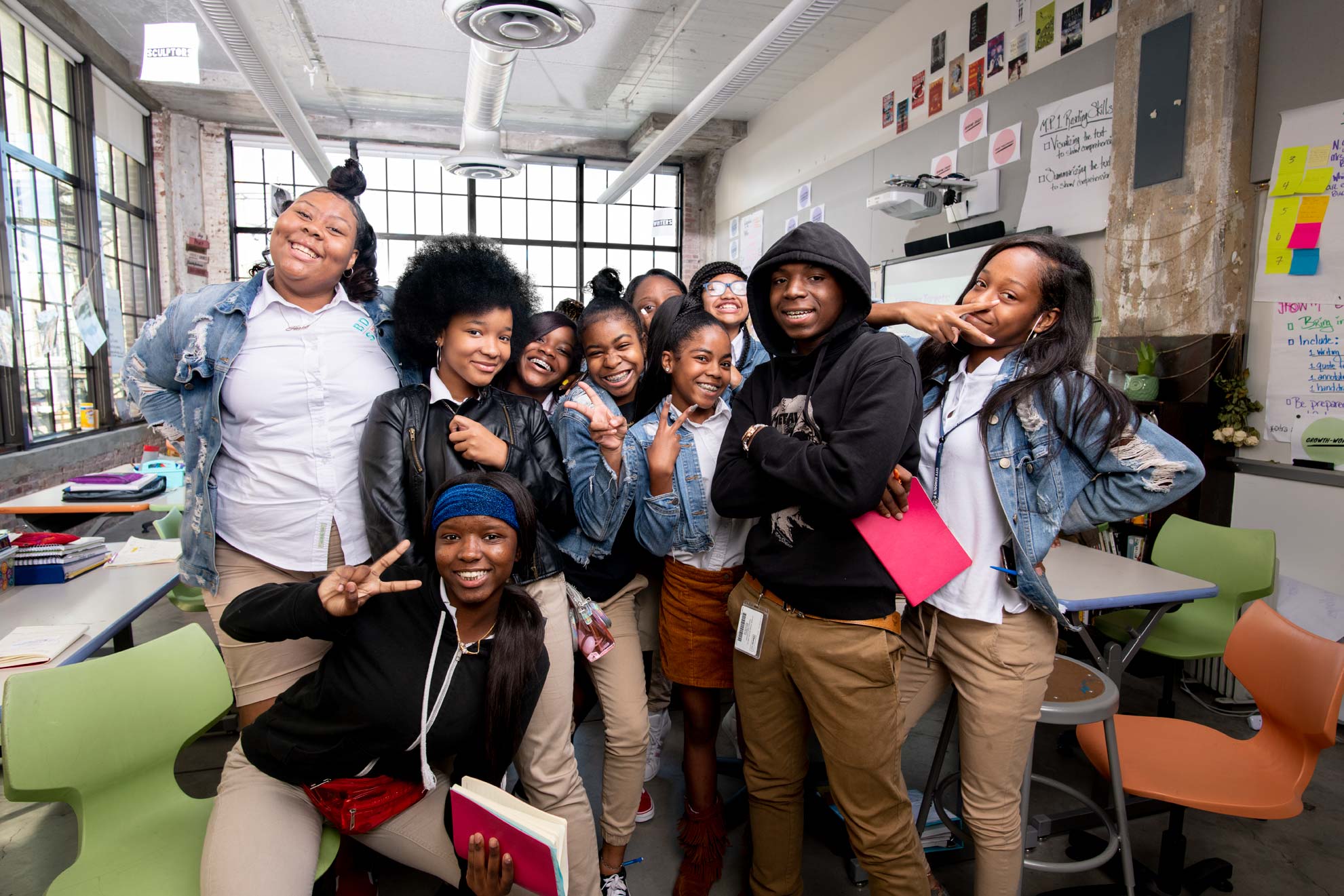 A group of kids posing for the camera in their classroom at the Baltimore Design School