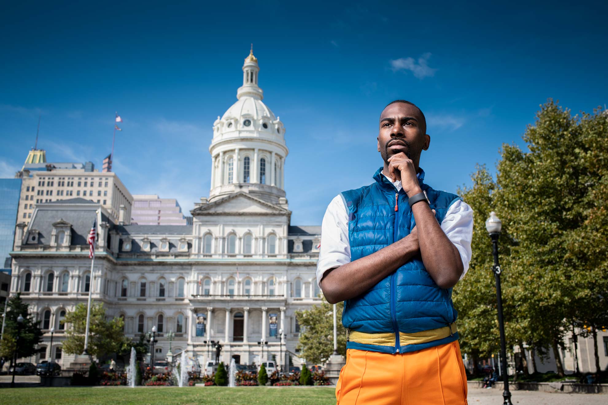 Social activist DeRay Mckesson wearing his signature blue vest in front of the Baltimore City Hall