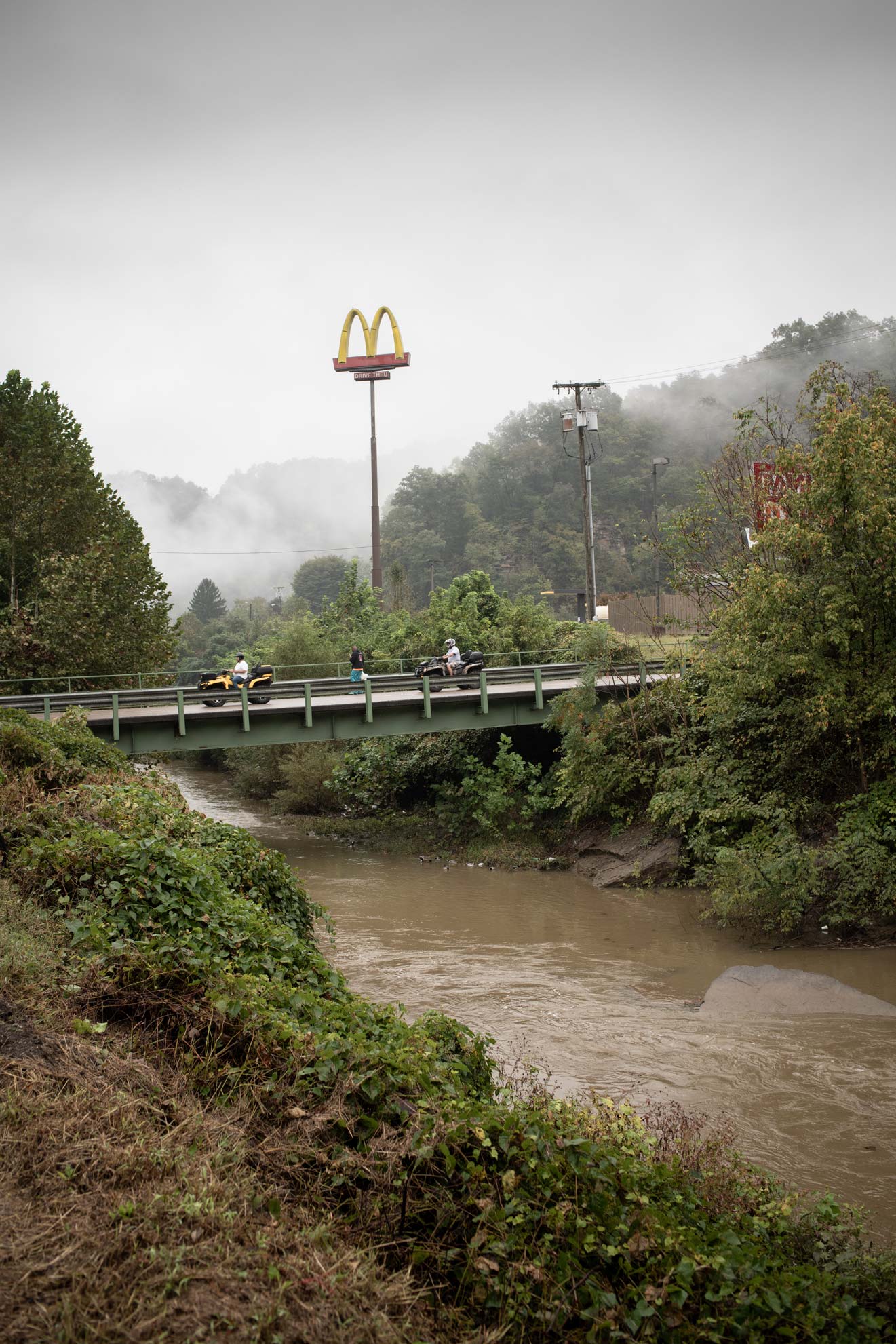 National Trailfest: ATV riders cross the river next to the McDonalds