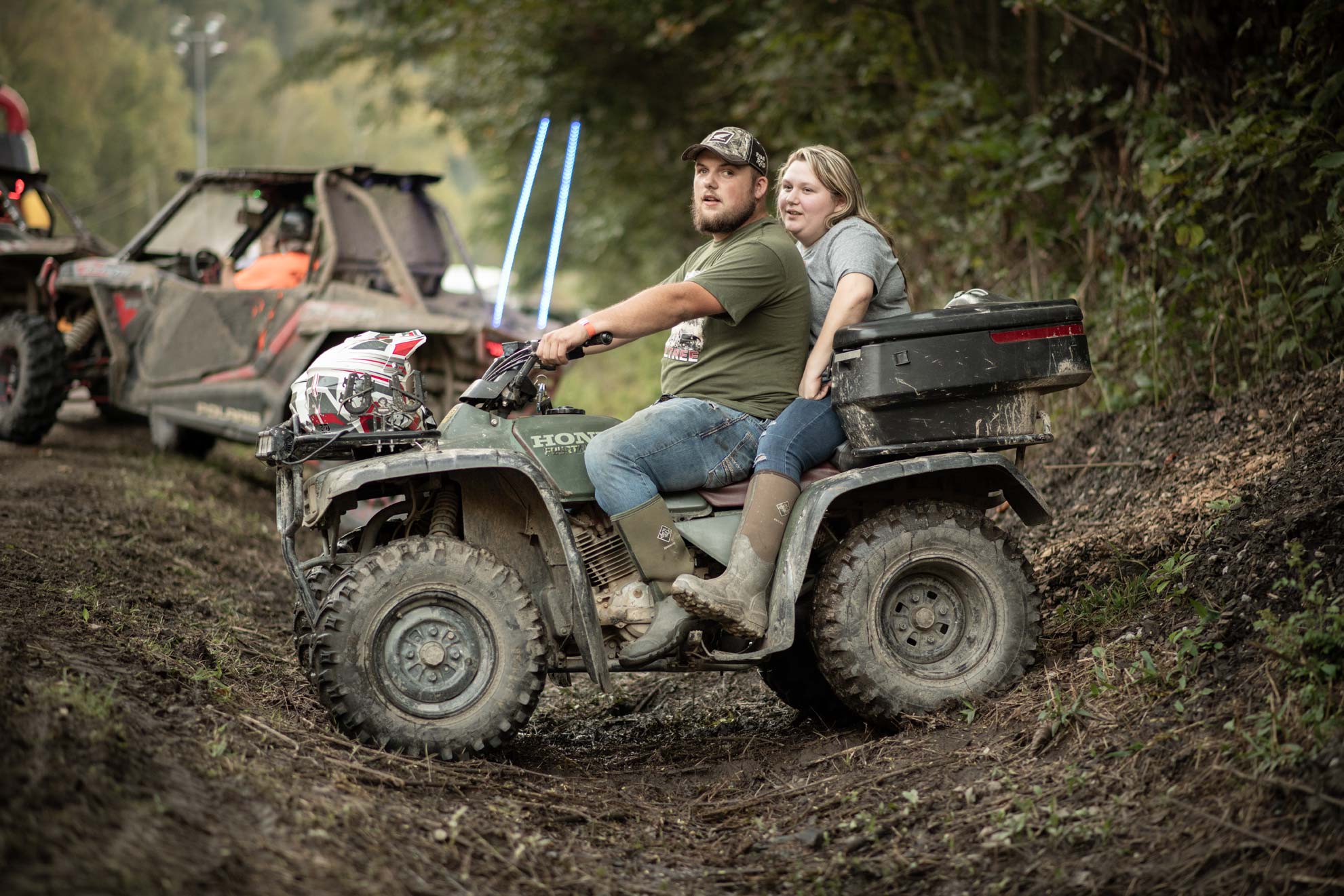 National Trailfest: A mand and a woman sit on an ATV in ditch waiting to ride