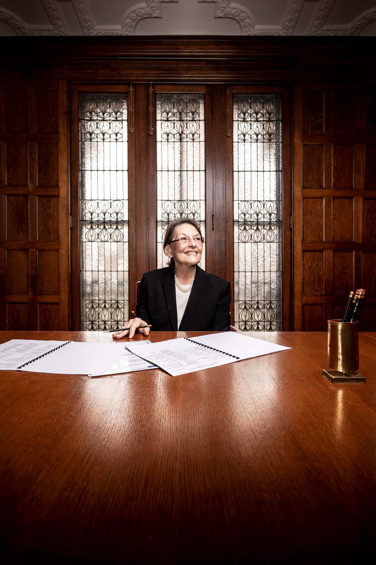 Divorce attorney Sheila Sachs seated at a desk in front of a large window