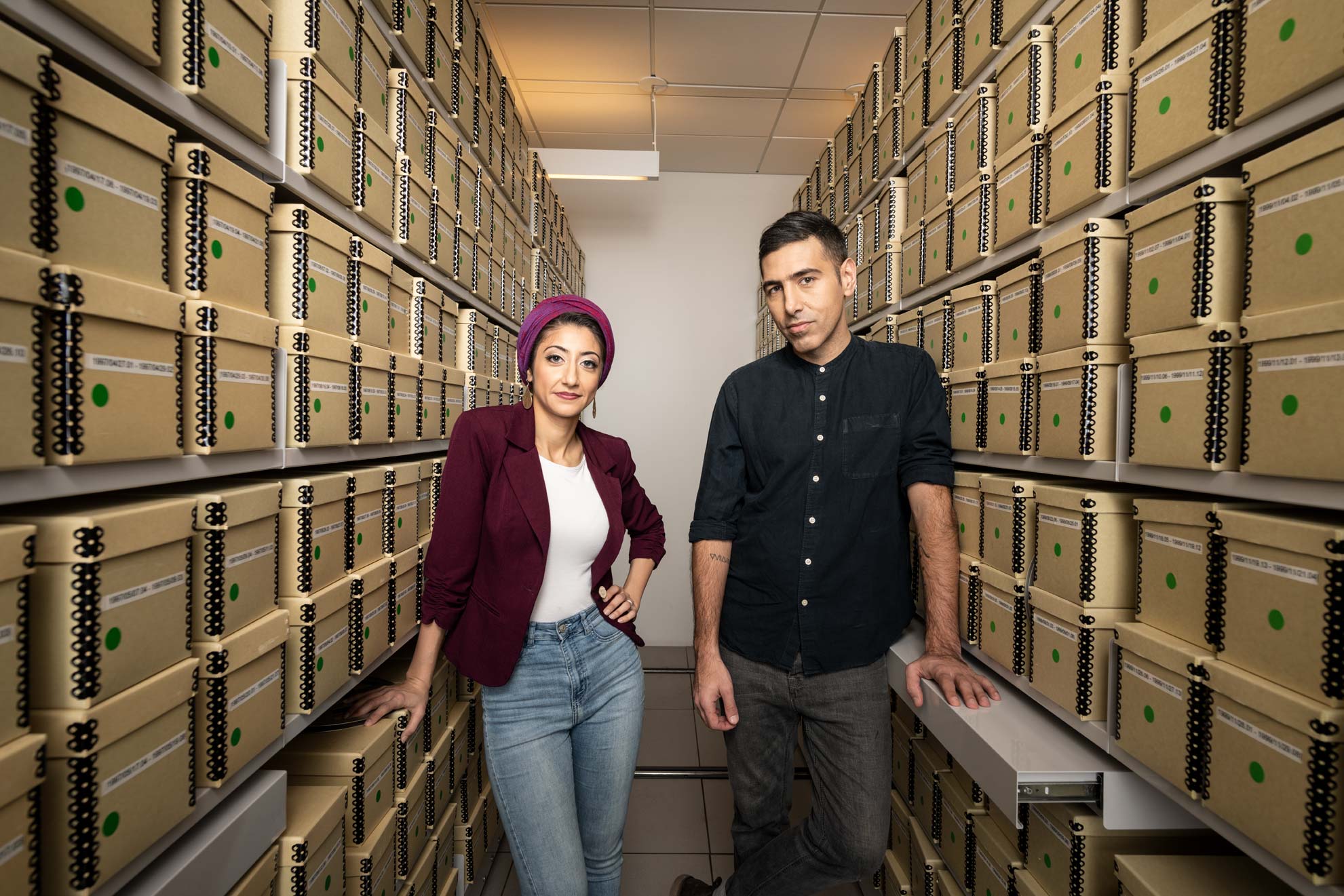 Rund Abdelfatah and Ramtin Arablouei standing in the NPR archives room
