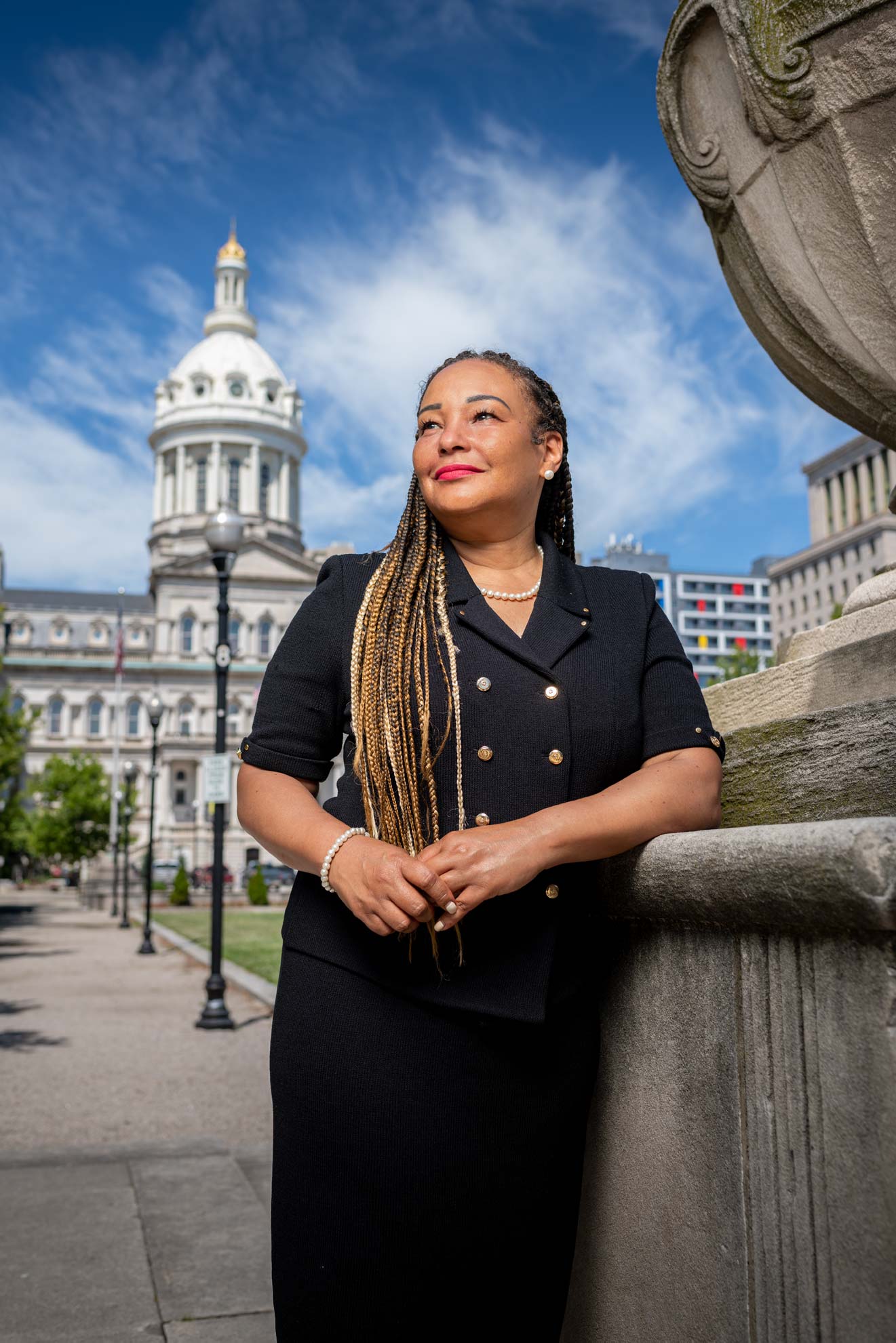 Maryland State Senator Jill Carter resting against a wall in front of Baltimore