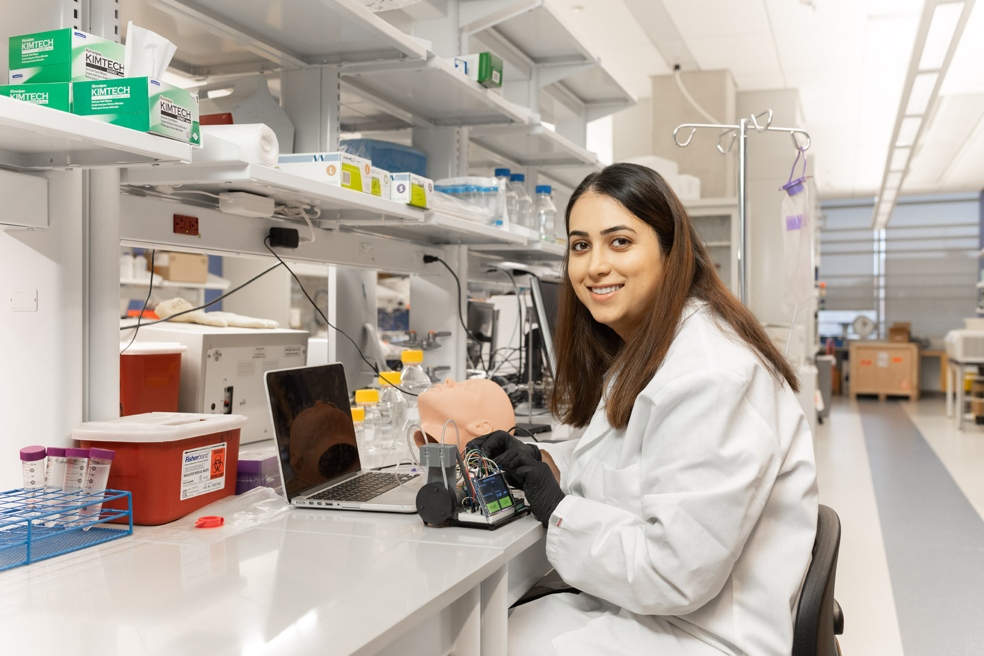 A female scientist sitting at a table in a laboratory