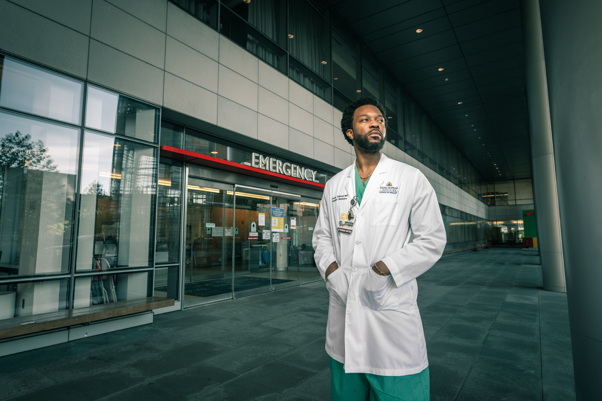Dr. Mustapha Oladapo Saheed wearing a lab coat in front of the emergency entrance