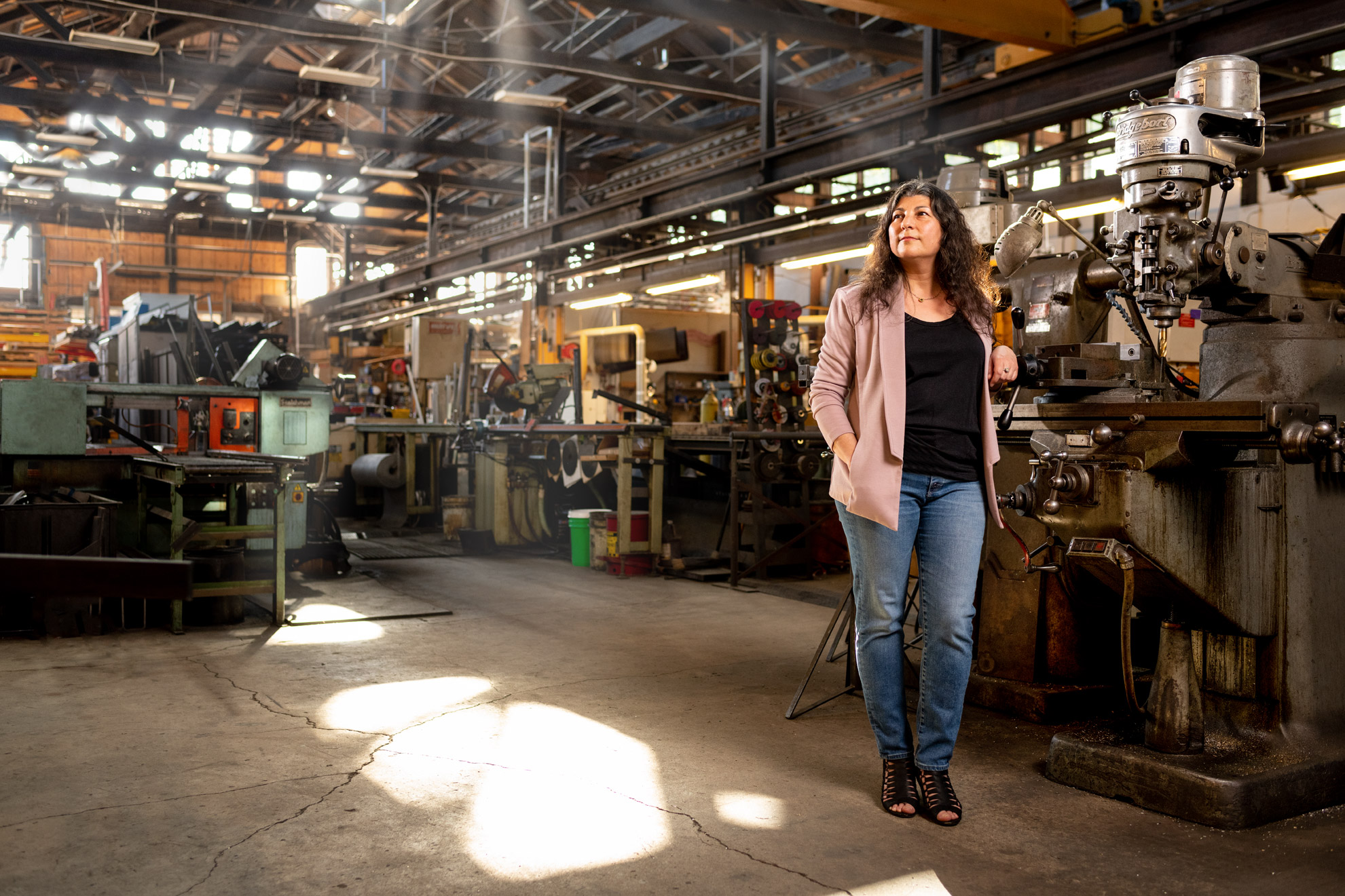 Roya Golpira standing on the factory floor at John Gutierrez studios