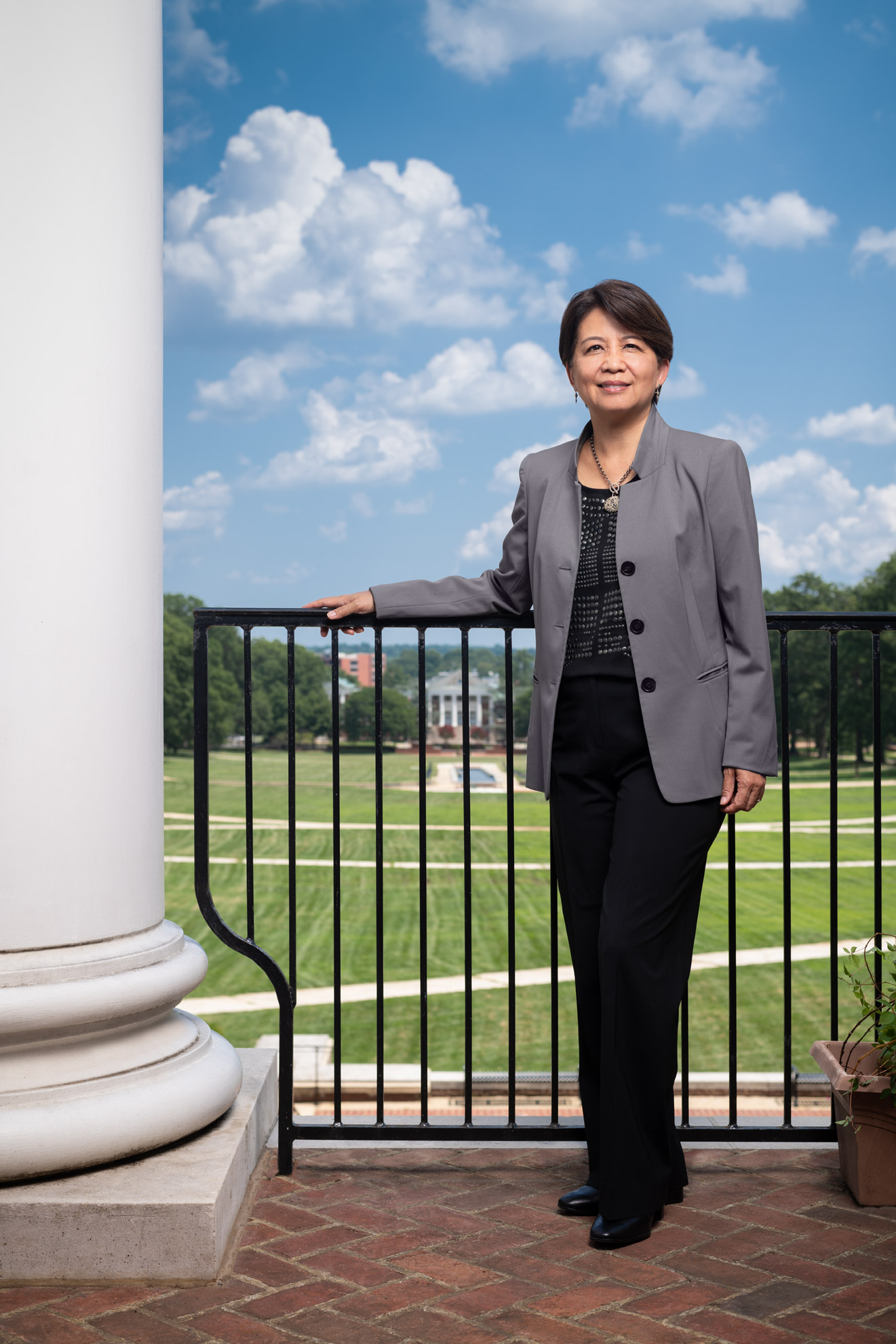 University of Maryland Libraries Dean Adriene Lim stands with the campus behind her