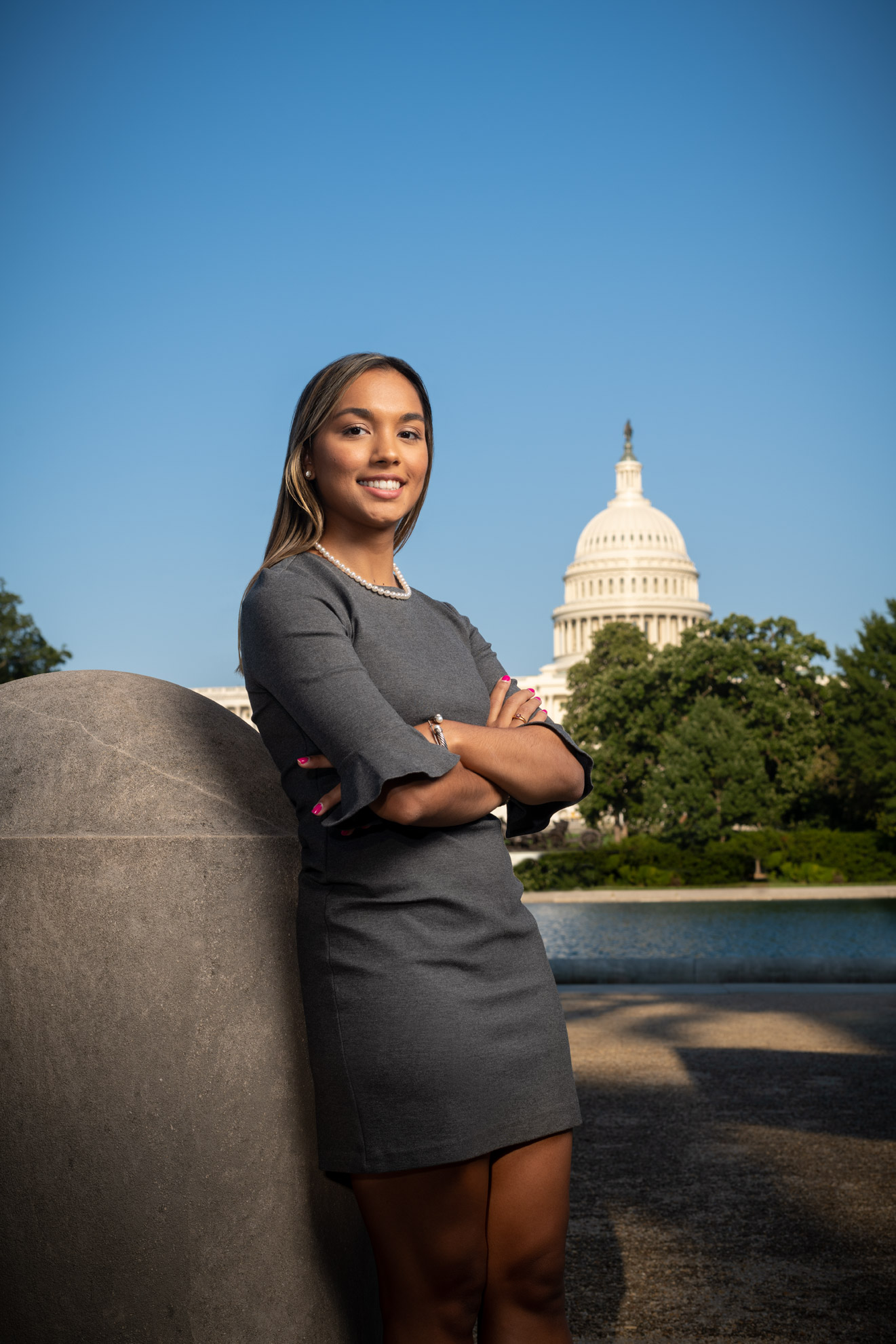 Julia Sircar standing in front of the US Capitol building with her arms crossed