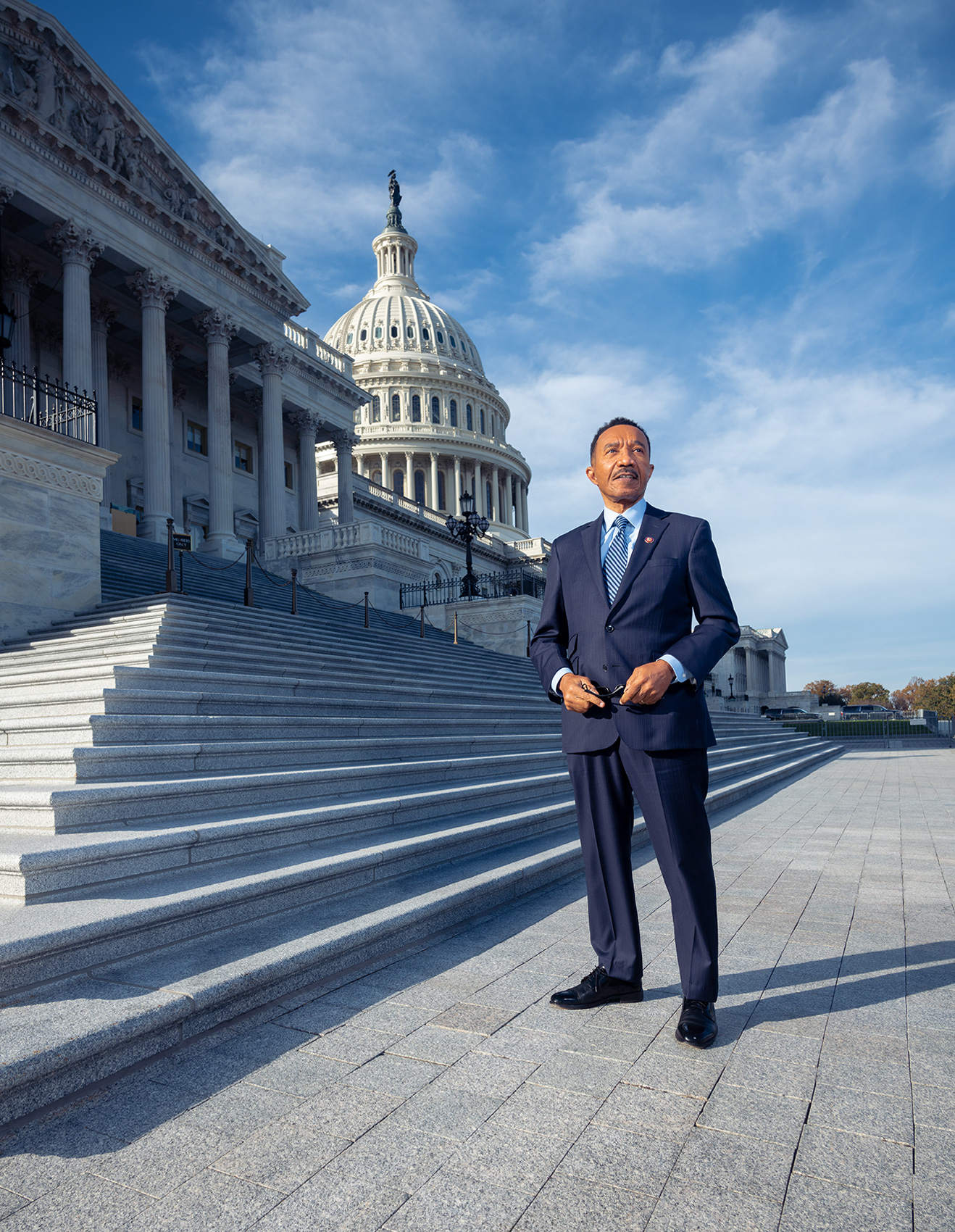 Congressman Kweisi Mfume standing on the steps of the US Capitol