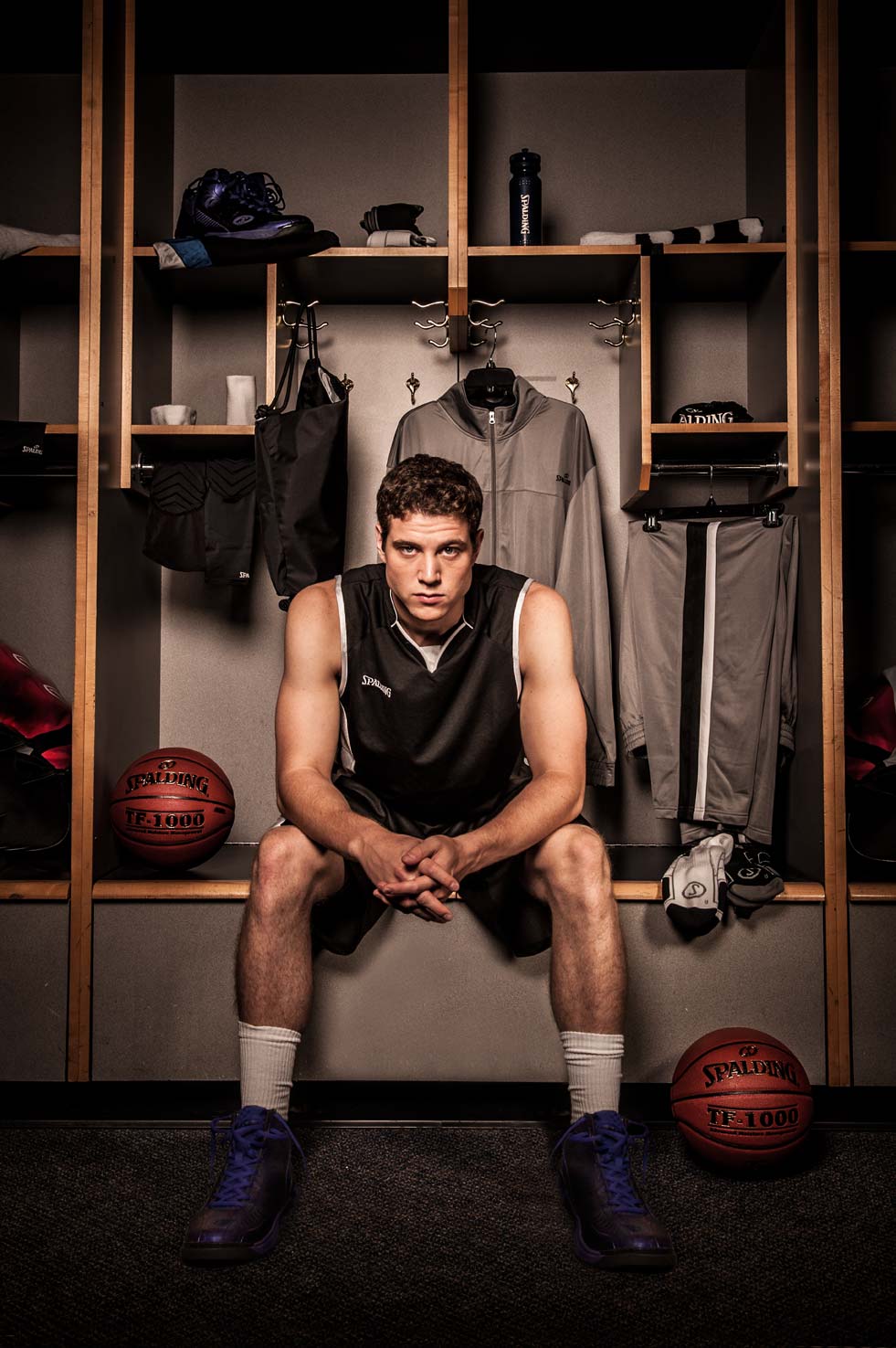 Jimmer Fredette seated in a basketball locker room giving his game face